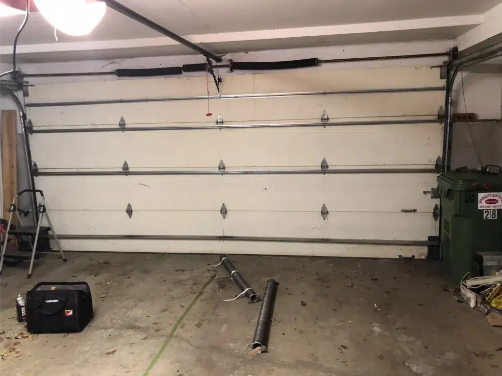 white garage door receiving winter repairs