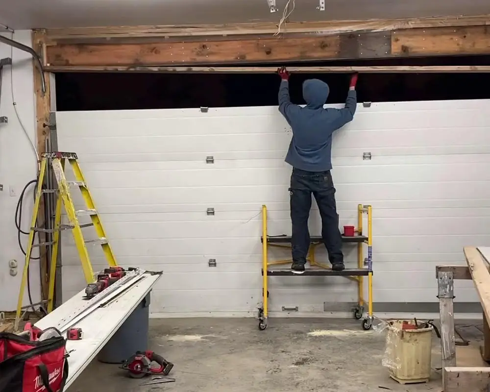 garage door repairman installation of new panels