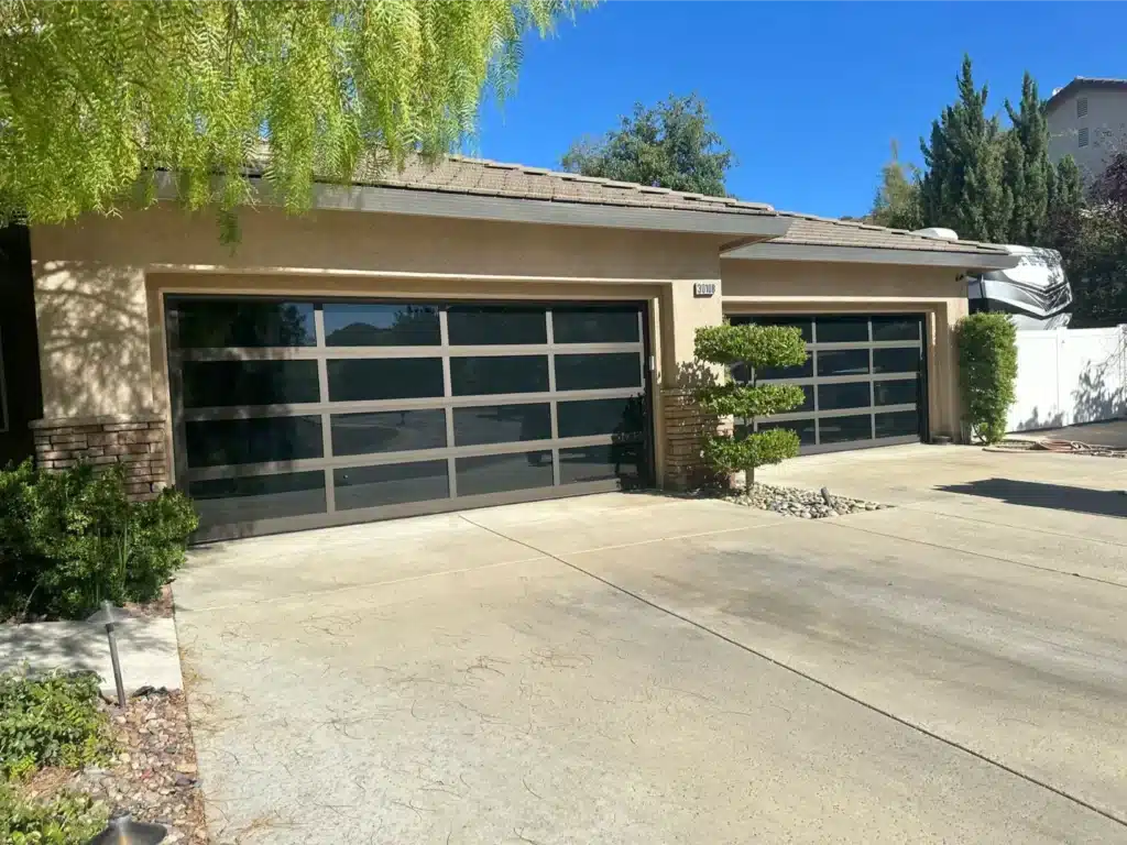 dual garage doors made of black glass