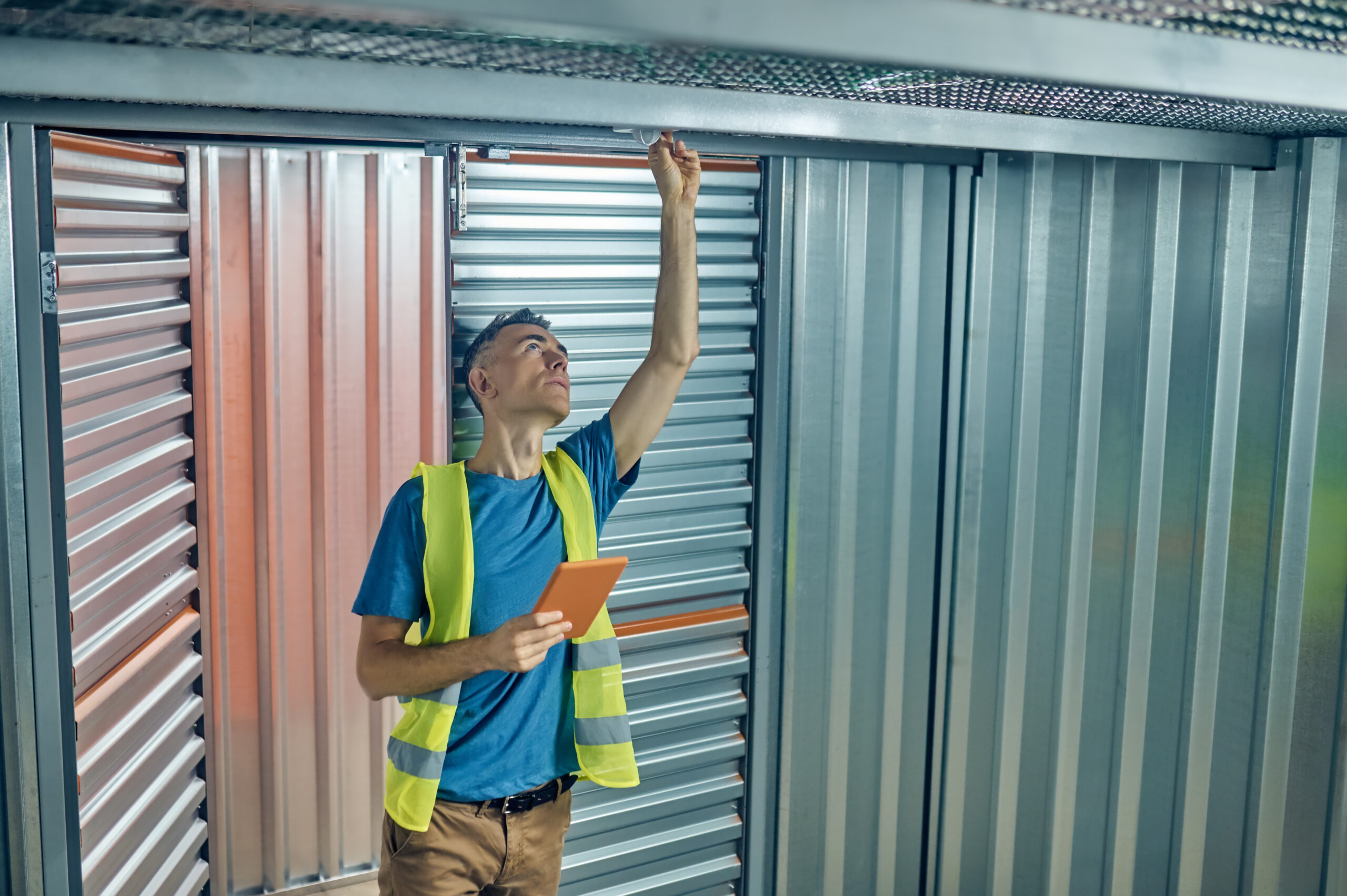 Gold Garage Door technician servicing and repairing a commercial roll-up door in Los Angeles